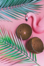 Plastic Flamingo, Coconut Shells And Tropical Palm Leaves On Pink Background. Hot Summer Vacation Concept. Flat Lay, Top View.