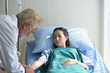 © tharathip - The doctor is examining the patient and encouraging the patient to stay in the hospital.