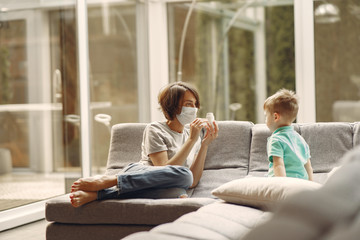 Family stay at home. Mother with little son. Coronavirus theme. Mom gives baby pills.