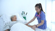 © S photographer - Medical concepts. Young nurse measuring the pressure of elderly patients in the hospital. 4k Resolution.