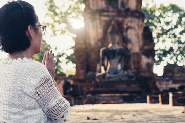 Wall Mural - Blurred Background antique buddha pagoda statue in Thailand Ayutthaya buddhist ancient temple. Thai tourist pray for good luck, zen peaceful and holy meditation relax.