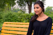 © Ranta Images - Happy young beautiful Persian woman relaxing at the park