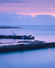 Canvas Print - Sunset in the sky over the Guernsey Yacht Club and Model Pond