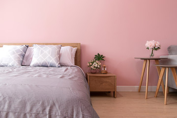 bedroom Interior of room with comfortable bed near pink wall,