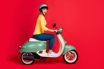 Poster - Profile side view portrait of her she nice attractive lovely glad girlish cheerful cheery girl riding moped having fun weekend isolated on bright vivid shine vibrant red color background