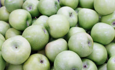 Lots of green apples. Apples storage. Bunch of green apples in a box in supermarket