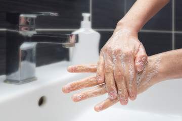  Woman washing hands with soap. An unrecognizable female showing how to wash hands properly. Coronavirus or COVID-19 prevention