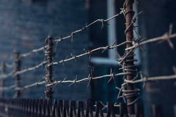 barbed wire stretched in 3 layers on the fence