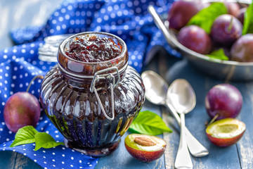 Sticker - Plum jam in a glass jar and fresh fruits with leaves