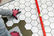 © ronstik - tiler laying marble texture hexagon tiles on the bathroom floor
