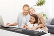 © Angelov - family plays the digital piano at home, learning online, family rest during quarantine, self-isolation, online education concept. support for loved ones concept