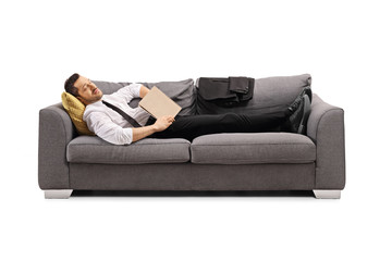 Wall Mural - Businessman sleeping on a sofa with a book