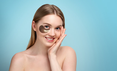 portrait of beauty woman with eye patches showing an effect of perfect skin. beautiful face of young