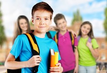 School Boy With Books And Backpack On Classmates Background