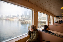 A Young Women Looking Out The Window Of A Ferry Boat On The Seattle Waterfront.
