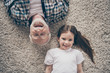 © deagreez - High angle top above photo of two people grandpa little granddaughter lying floor cozy fluffy carpet cheerful positive good mood stay home quarantine living room indoors