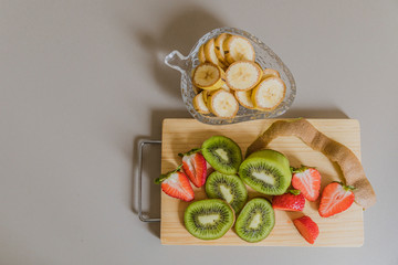 pieces of fruit on top of a wooden board