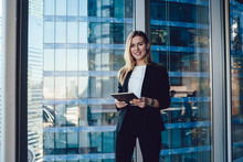 Half Length Portrait Of Caucasian Female Entrepreneur With Modern Touch Pad In Hands Smiling At Camera Posing In Office Interior, Prosperous Business Woman In Elegant Suit Holding Digital Tablet