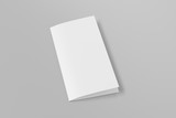 Fototapeta Tematy - Blank square leaflet on gray background. Bi-fold or half-fold closed brochure isolated with clipping path. Side view. 3d illustration