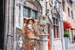 a girl looks at a historic building in Bruges