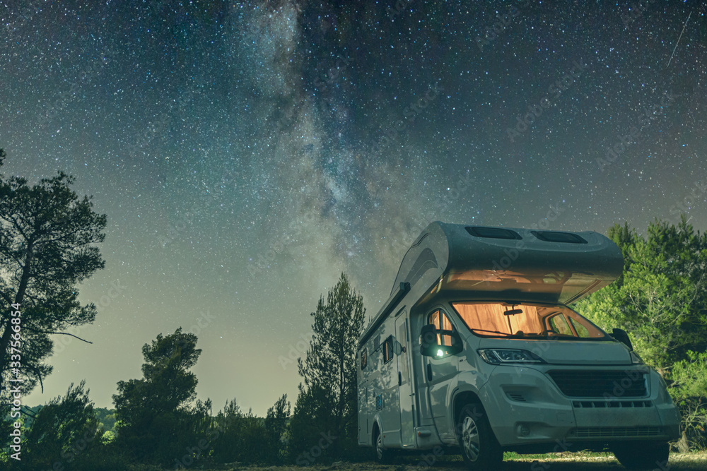 campervan caravan vehicle for van life holiday on mobile home camper mobile motor home RV campervan for an outdoor nomad lifestyle camper van journey camping in the parking space night sky with stars - obrazy, fototapety, plakaty 