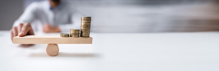 Finger Balancing Stacked Coins On Seesaw