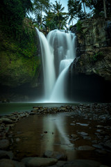 Wall Mural - Waterfall landscape. Tegenungan waterfall in tropical rainforest. Amazing water reflection. Slow shutter speed, motion photography. Ubud, Bali, Indonesia