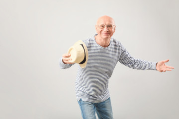 Poster - Portrait of happy elderly man on grey background