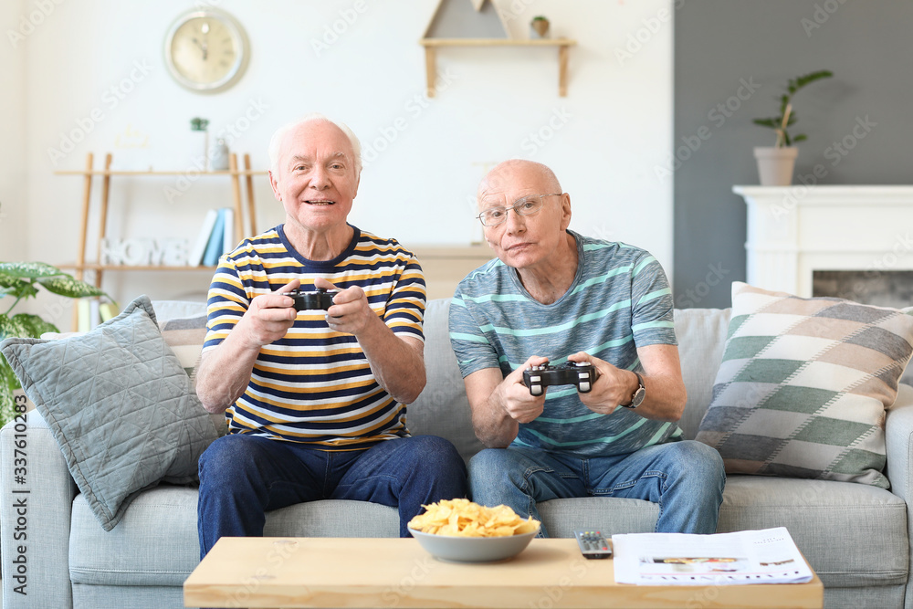 Elderly men playing video games at home