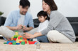 © 浩然 张 - Young Asian mom and dad are building blocks with their daughter