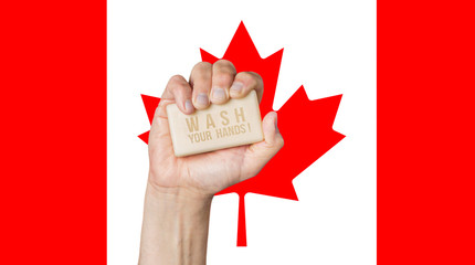 Canvas Print - Male hand holding soap with words: Wash Your Hands, against a Canadian flag