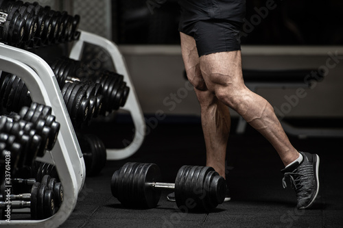 Cuadros en Lienzo healthy body part concept of young strong male bodybuilder legs in trunks and sn