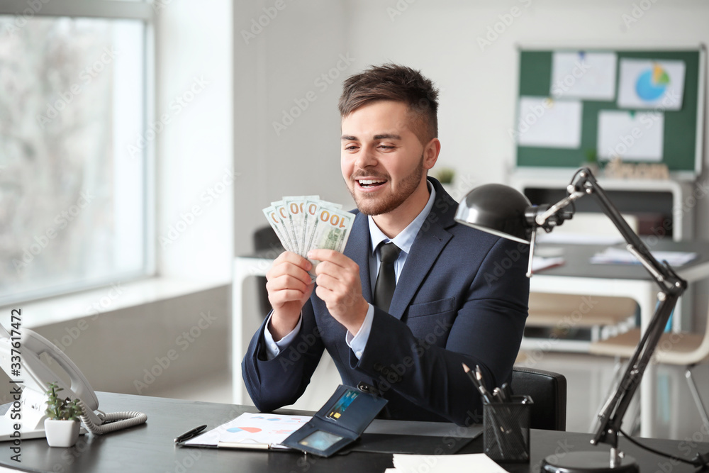 Businessman counting money in office