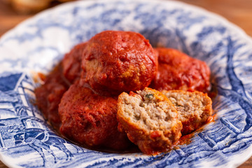 Wall Mural - Homemade beef meatballs with tomato sauce on wooden table. Italian food.