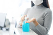 © sattahipbeach - Woman wearing face mask protective for spreading of disease virus SARS-CoV-2 and hand wash cleaning by alcohol gel in office working for protection bacteria and virus, Covid-19 Coronavirus concept
