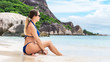 © 22Imagesstudio - Beautiful woman at the tropical beach Anse Source d'Argent on La Digue island, Seychelles.