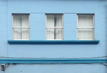 Exterior Of Blue Building With Windows