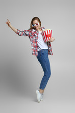 Full Length View Of Smiling Caucasian Woman In Red-blue 3d Glasses Holding Bucket With Popcorn Isolated On Pink Background.