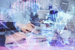 © peshkova - Double exposure of businessman working on laptop on background. International business hologram in front. Concept of success.