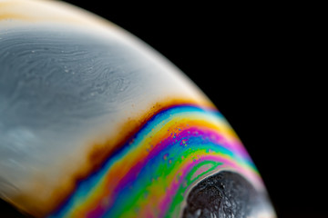psychedelic abstract planet from soap bubble, light refraction on a soap bubble, macro close up in s