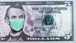 Coronavirus in United States. Quarantine and global recession. 5 American dollar banknote with a face mask against infection. Global economy hit by corona virus outbreak and pandemic. Montage. Concept