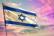Fluttering Israel Flag On Colorful Cloudy Sky Background. Prosperity Concept.