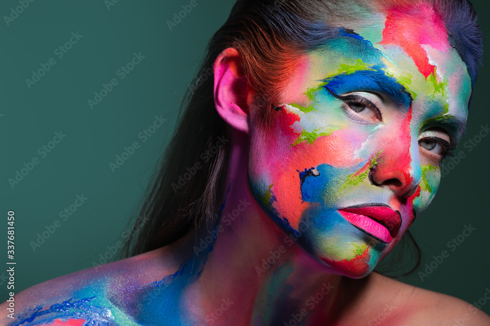 Face art and creative makeup, a young beautiful woman abstract art on the face - obrazy, fototapety, plakaty 