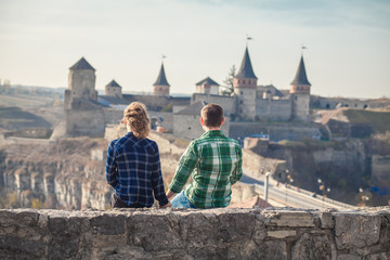 romantic couple sitting on a roof