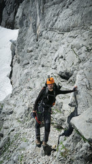 Wall Mural - Tourist with equipment on the via ferrata trail in the alps