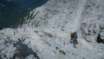 Wall Mural - Tourist with equipment on the via ferrata trail in the Dolomites