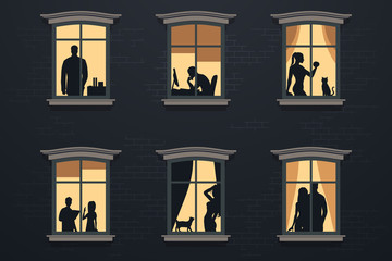 People in windows at night