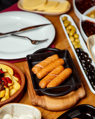 Poster - fried sausages on a tray with french fries and olives