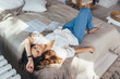 © undrey - Portrait of woman relaxing on bed in living room
