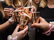Hands of the bride and bridesmaids holding cups at a bachelorette party - raising a toast